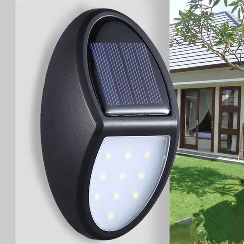 Black rectangular LED solar wall light mounted on an exterior wall for automatic night-time illumination.