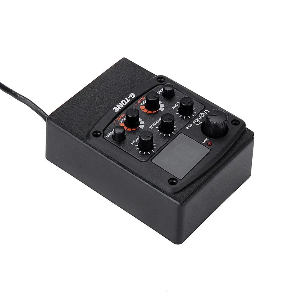 Cherub GT-6 black acoustic guitar preamp with EQ and effects knobs mounted in a guitar soundhole.