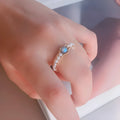 Grey Moonlight Pearl Ring with natural moonstone and blue labradorite crystal on finger, women's ring size model