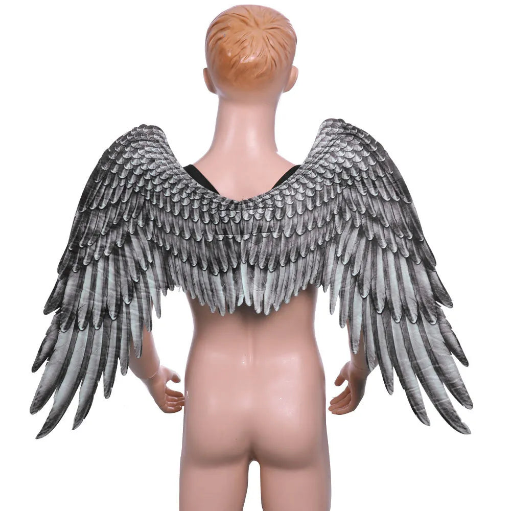 White 3D angel wings costume accessory made from non-woven fabric on child, 33cm by 68cm by 54cm