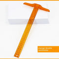 Orange-yellow plastic T-square ruler showing 30 cm scale and right-angle edge for drafting.