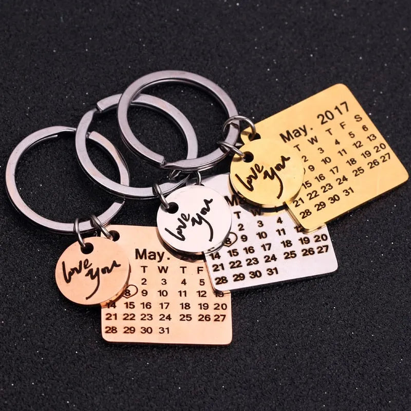 Stainless steel calendar keychain with custom engraved date in silver finish on neutral background