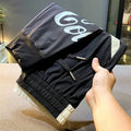 Man wearing black ultra-thin ice silk cropped trousers with elasticated ankle bands.