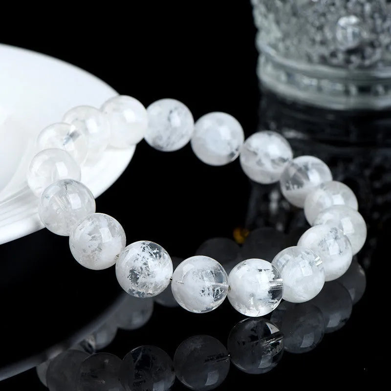 Close-up of a women's bracelet with round geometric crystal beads in a natural blizzard snowflake finish, showing Ruyi and Xiangyun design details.