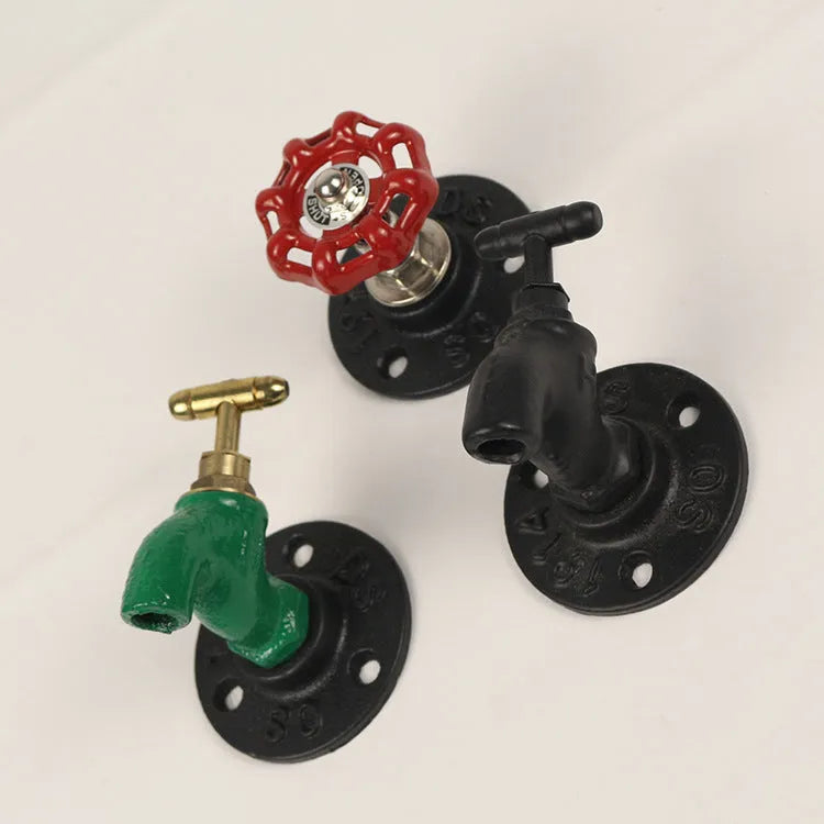 Modern minimalist metal towel rack hook mounted on a wall, shown in black faucet finish.