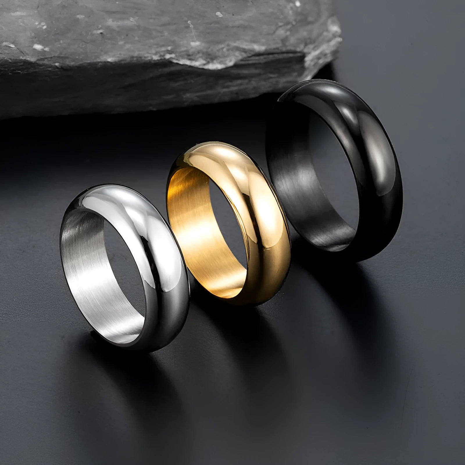 Glossy electroplated titanium steel ring in gold, black, and steel colour showing size range 7-12