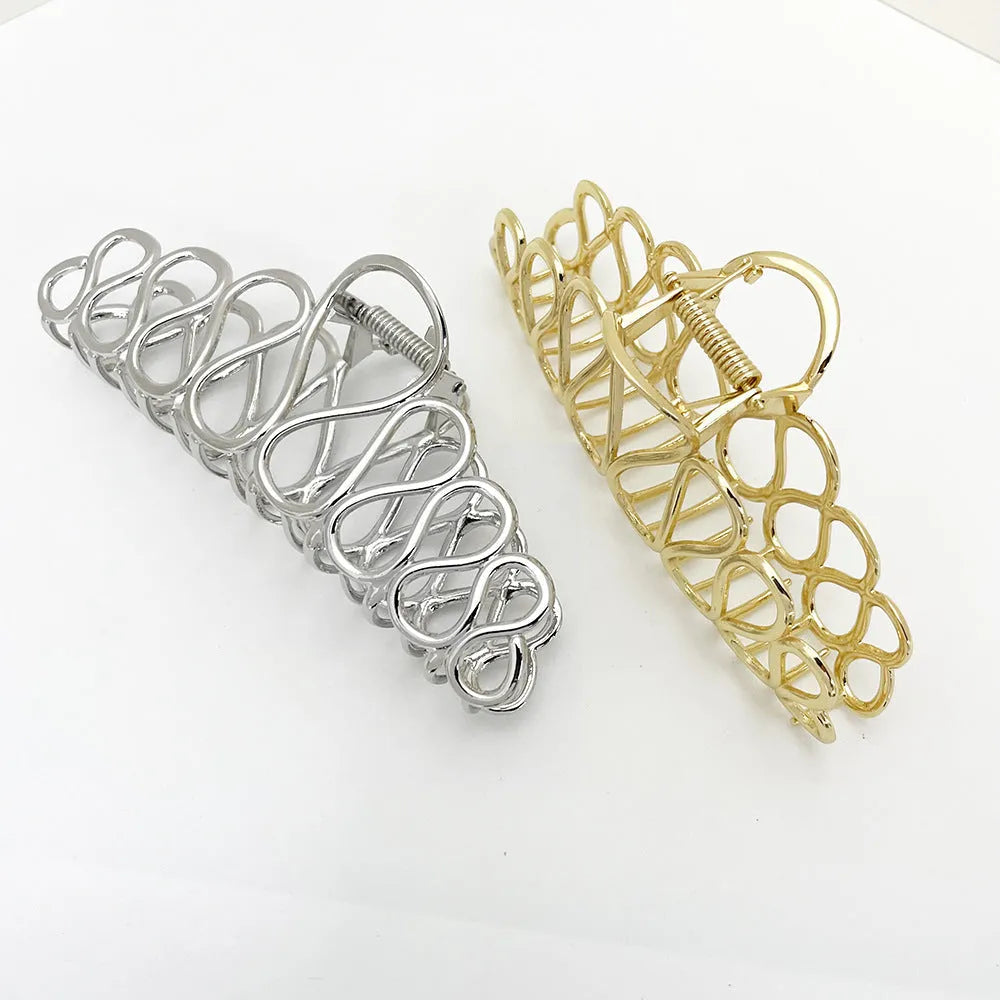 Minimalist large hair clip with electroplated finish and tassel detail.