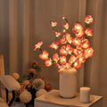 Pink LED Phalaenopsis orchid branch decorative light measuring 65cm long for bedroom walls.