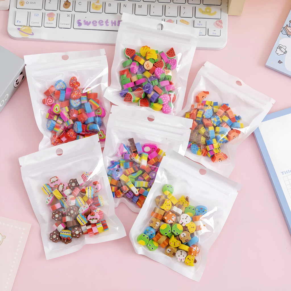 Assortment of 50 colourful cartoon-themed mini erasers including fruit, animal, and holiday designs.