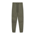 Man wearing dark grey loose-fit ankle-tied polyester running trousers for fitness.