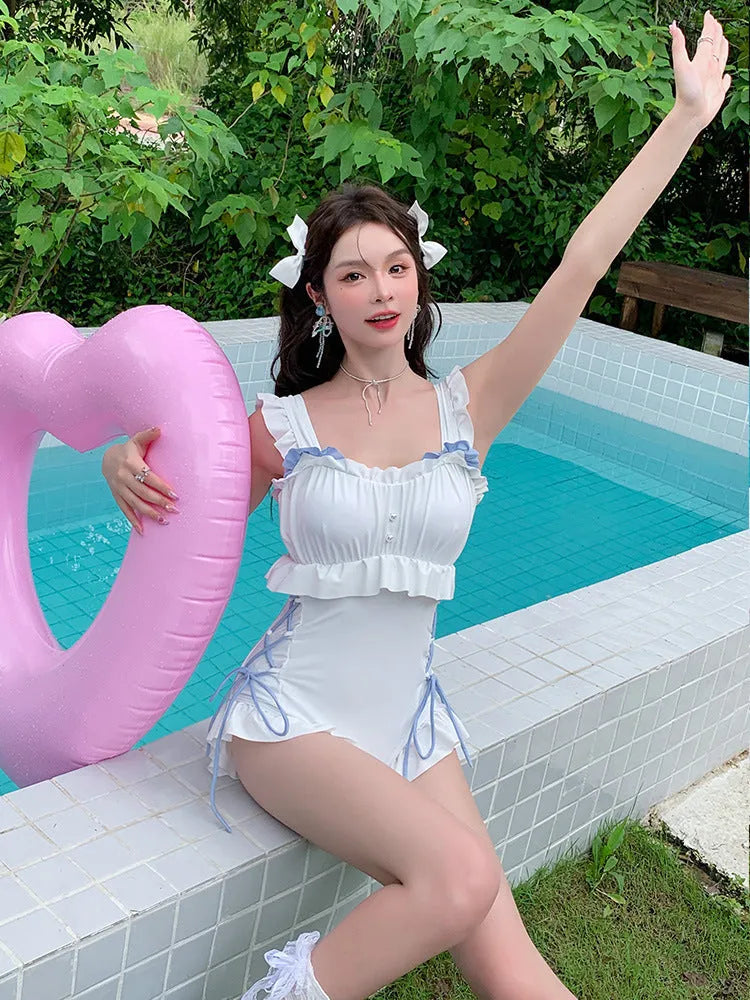 Women's milky white backless one-piece swimsuit made from nylon fabric.