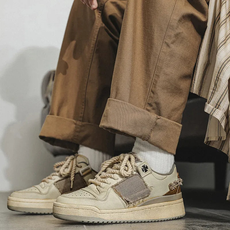 Beige vintage patch skateboard shoes with low-top design and round toe