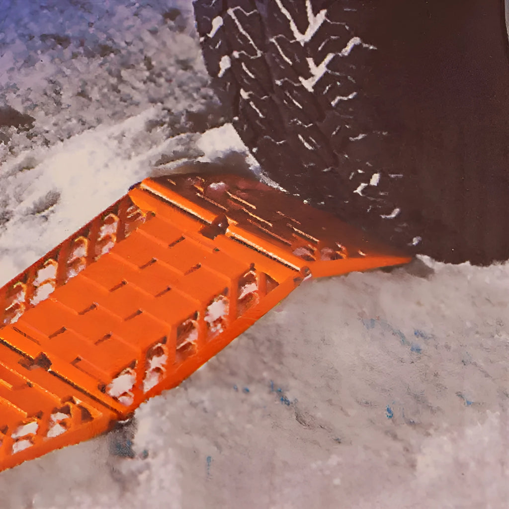 Orange folding rescue boards for vehicle recovery in mud and snow conditions