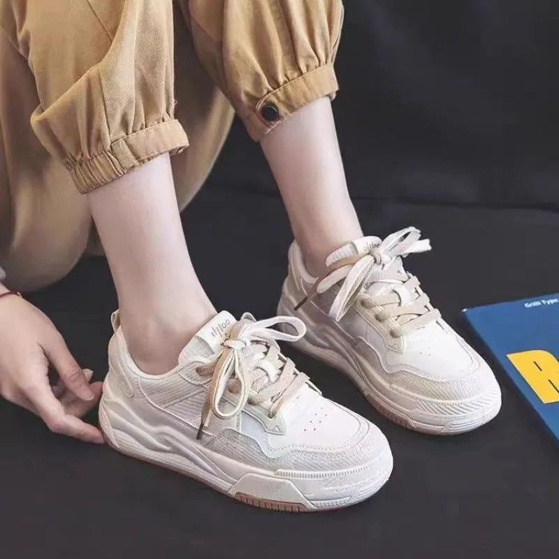 Beige and pink women's low top sneakers with a height increasing sole.