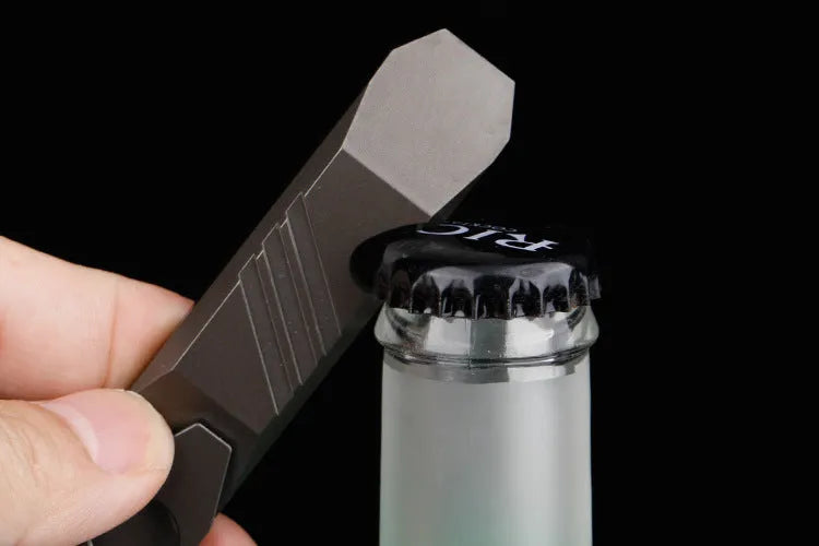 Titanium alloy multi-function crowbar tool with integrated bottle opener in gun grey or stone wash finish.