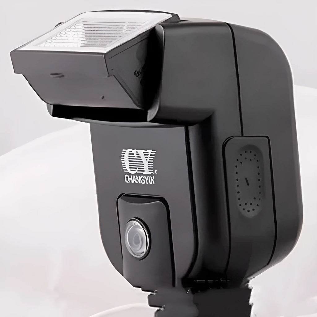 Compact silver SLR camera flash unit tilted on a hot shoe mount.