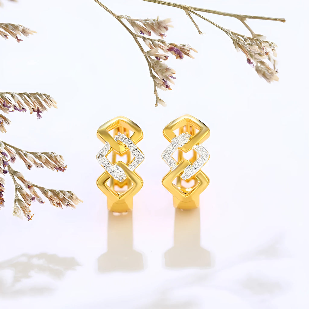 Gold electroplated geometric hollow-out earrings with ear clip fastening on white background