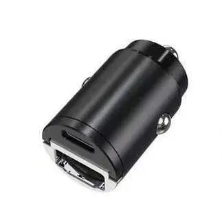 Black mini 30W dual USB car charger with zinc alloy housing next to a car cigarette lighter socket.