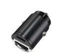 Black mini 30W dual USB car charger with zinc alloy housing next to a car cigarette lighter socket.