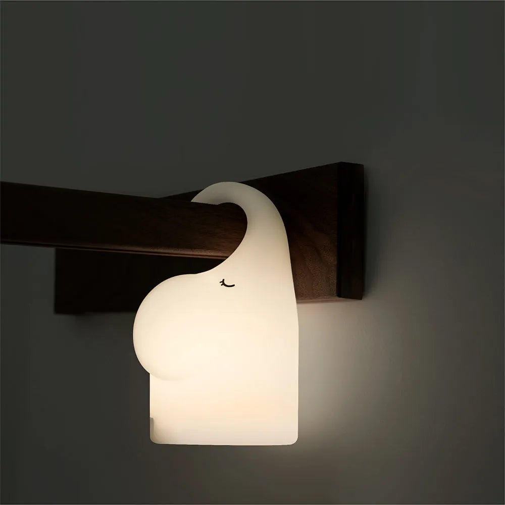 DOMI Elephant silicone night light with soft white glow on bedside table