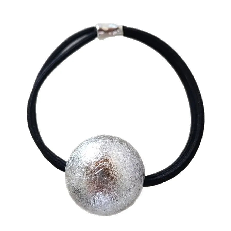 Resin hair band with electroplated gold finish, round head rope style, on a plain background