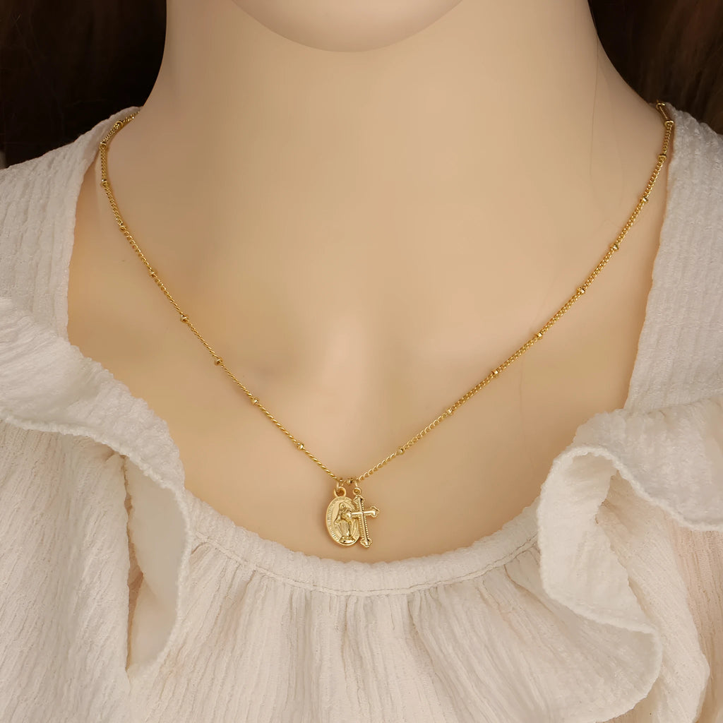Gold cross Virgin Mary pendant necklace with geometric design on adjustable chain for women