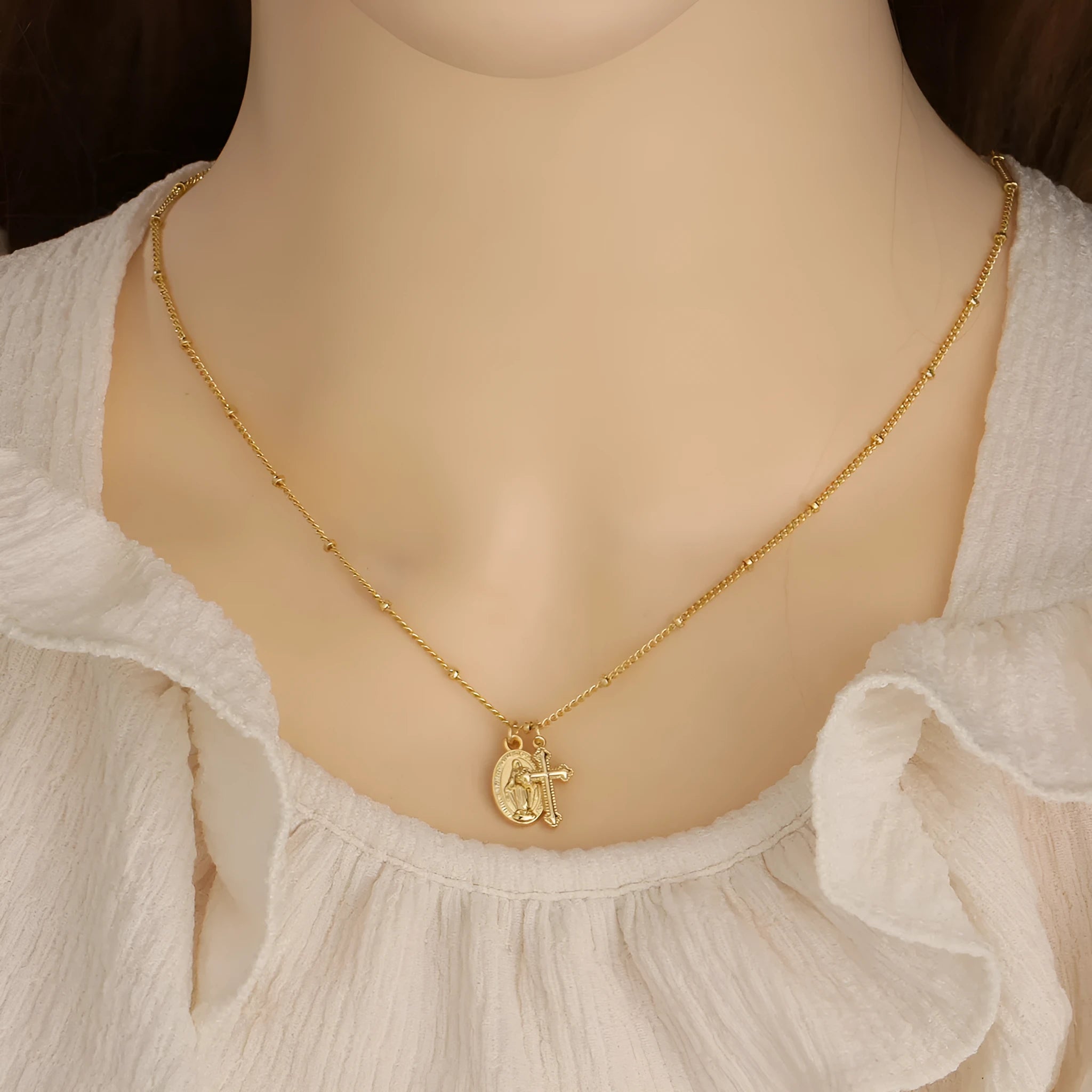 Gold cross Virgin Mary pendant necklace with geometric design on adjustable chain for women