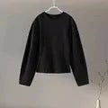 Women's black polar fleece suit set with long sleeve top and wide leg trousers