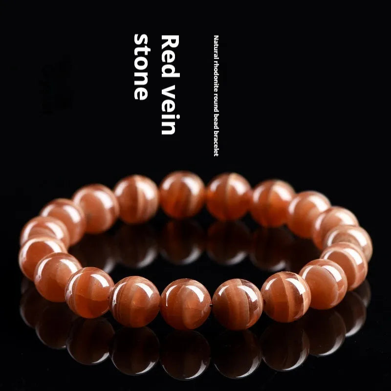 Peruvian rhodochrosite bracelet with geometric round beads in traditional ruyi design