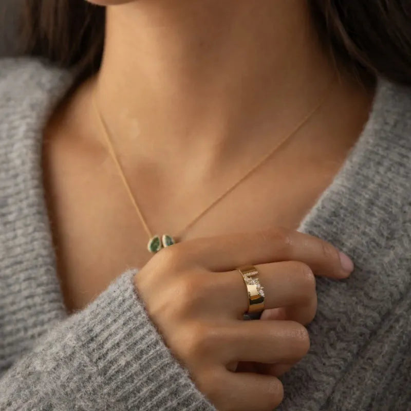Gold plated copper ring for women with shining zircon detail on a finger.