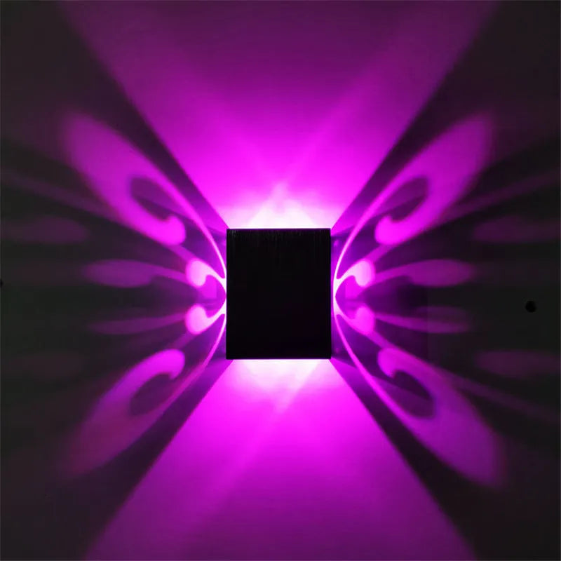 Modern aluminium butterfly-shaped LED wall lamp with remote control for changing light colours.