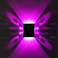 Modern aluminium butterfly-shaped LED wall lamp with remote control for changing light colours.