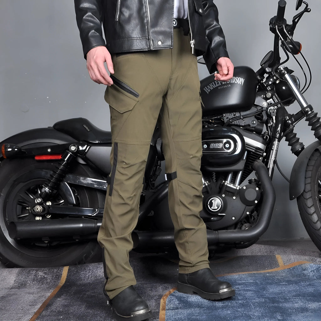 Men's green waterproof motorcycle trousers with belt and protective knee pads laid out flat.