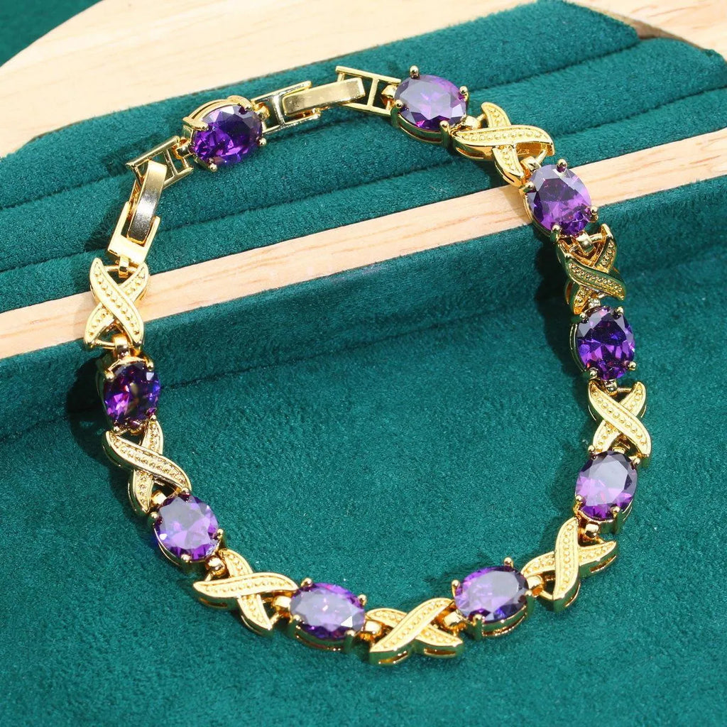Gold plated zircon jewellery set with necklace, earrings, ring, and bracelet on display.