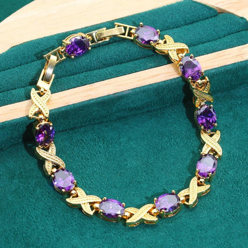 Gold plated zircon jewellery set with necklace, earrings, ring, and bracelet on display.