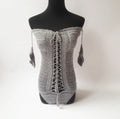 Women's off-shoulder one-piece swimsuit in light pink on a mannequin.