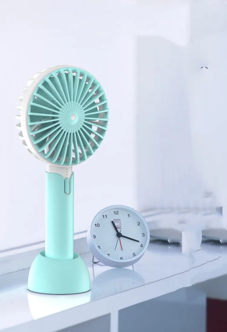 Blue handheld mini USB electric fan with three speed buttons and a shaking head.