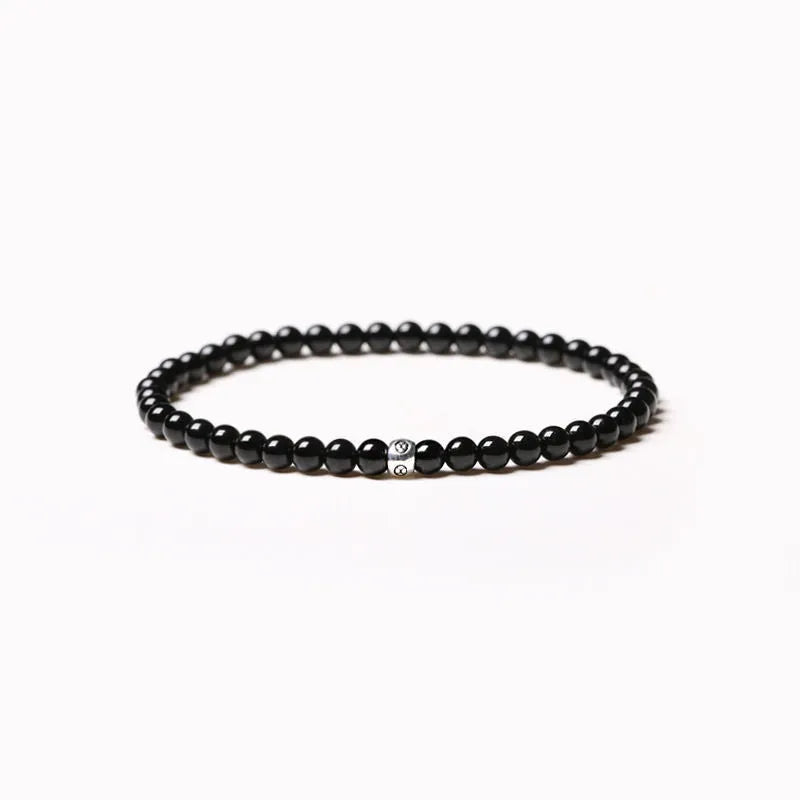 Unisex bracelet with black obsidian, blue San, and agate beads in round and square geometric shapes.