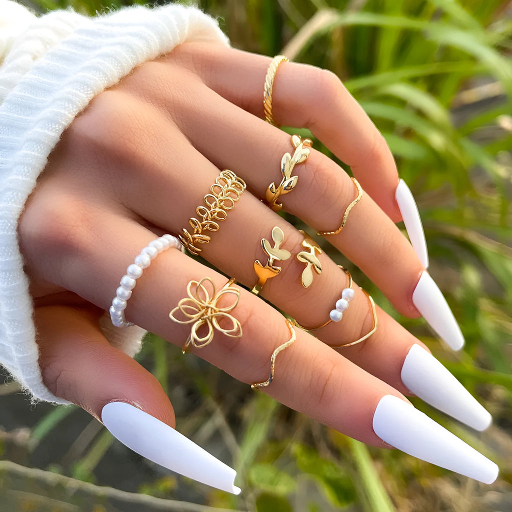 Gold-coloured alloy ring with openwork floral design and glossy electroplated finish