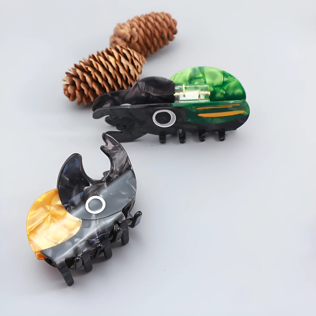 Handmade cellulose acetate beetle grip hair clip with cartoon caterpillar design in green, orange and white colours