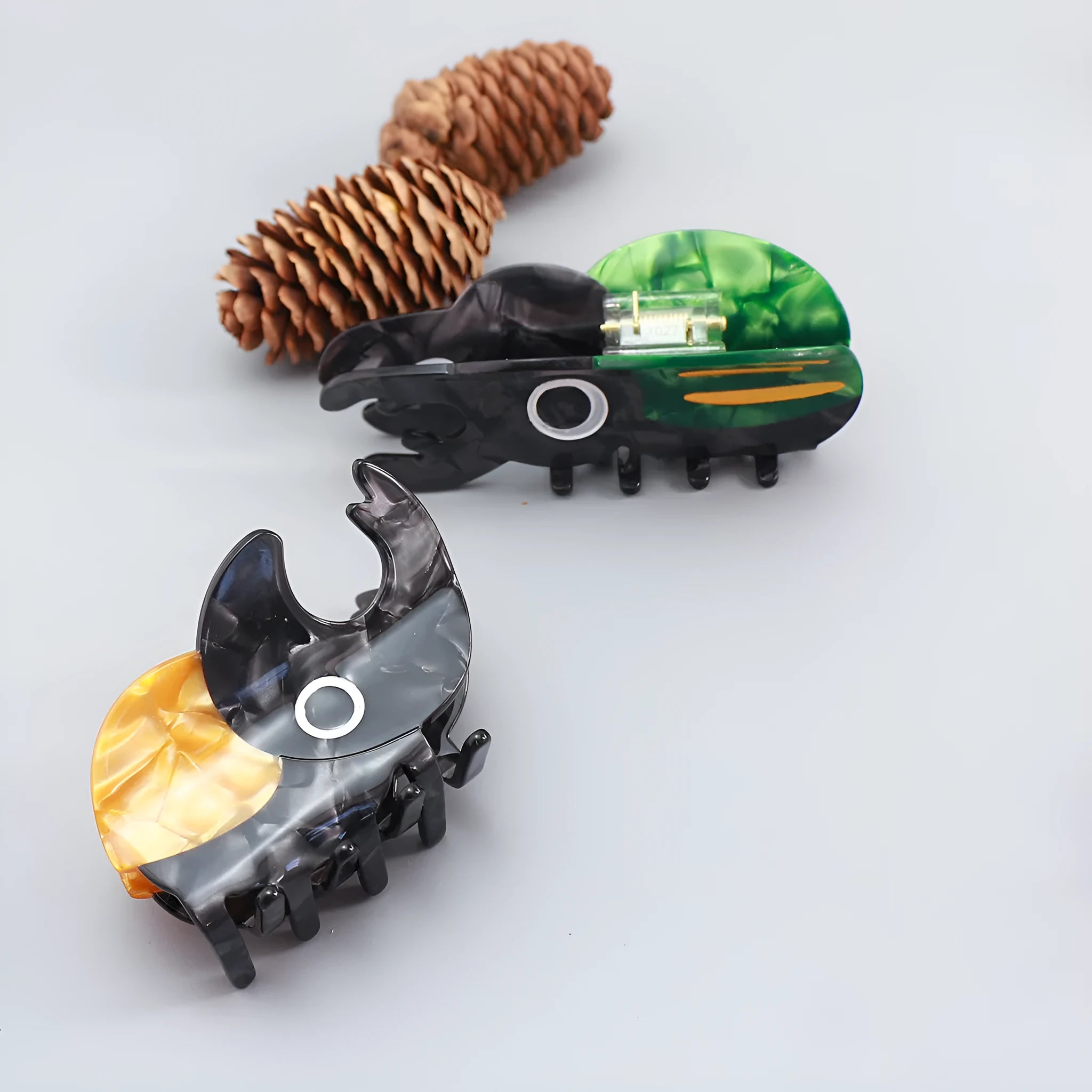 Handmade cellulose acetate beetle grip hair clip with cartoon caterpillar design in green, orange and white colours