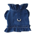 Blue denim dog dress with ruffle trim and metal leash attachment rings on chest and back