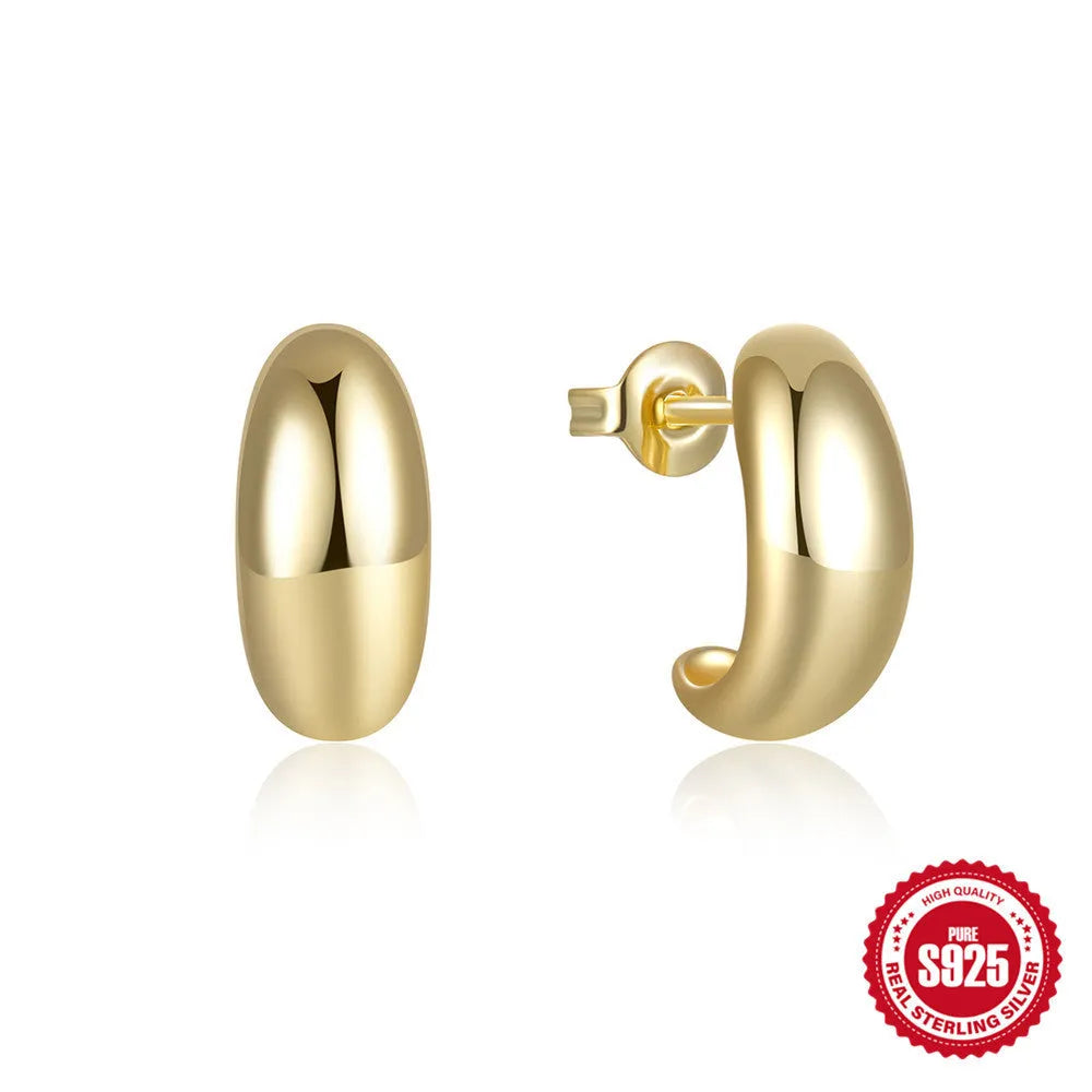 Close-up of a glossy C-shaped sterling silver stud earring with a post back, shown on a neutral background.