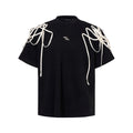 Black short sleeve T-shirt with rivet ribbon padded shoulder detail and loose round neck fit