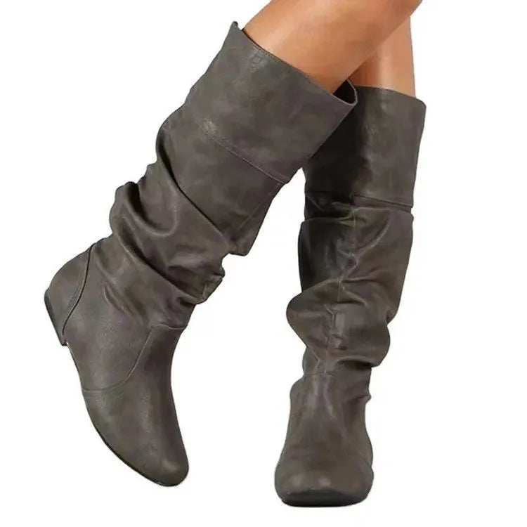 Women's flat heel black slip-on boots with round toe and high cylinder shaft.
