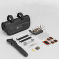 Bicycle tire repair kit in portable storage bag mounted on upper tube of bike frame