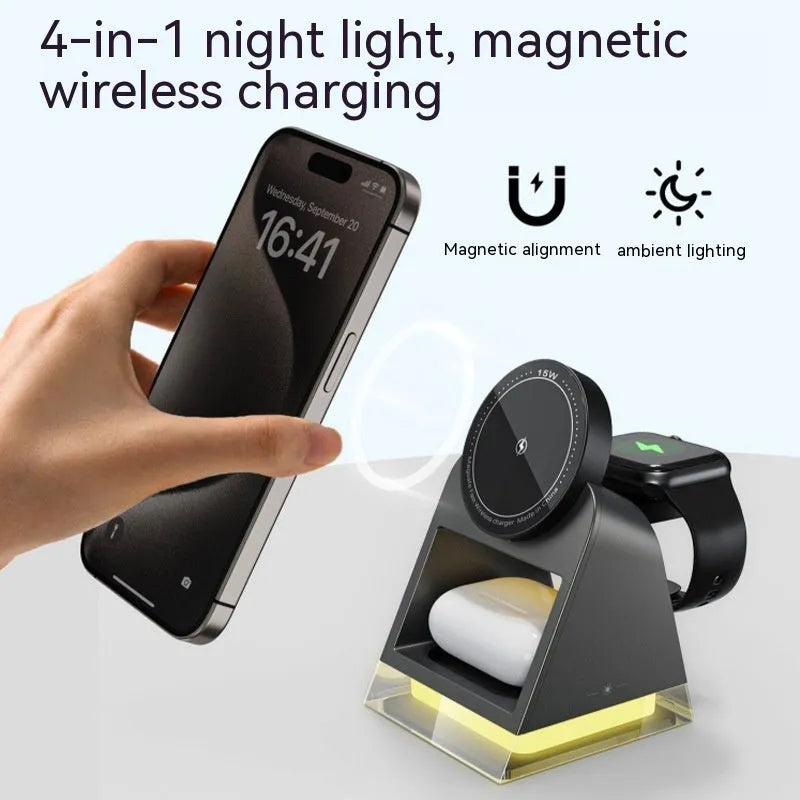 Black three-in-one magnetic wireless charger with night lamp charging phone, watch, and headset on a desk