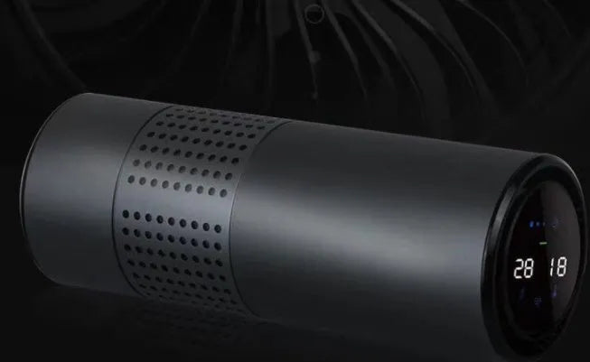Aluminium alloy car air purifier with display screen showing air quality, placed on a car dashboard.