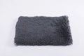 Plush pet nest in dark grey with anti-slip base, size M, on a wooden floor