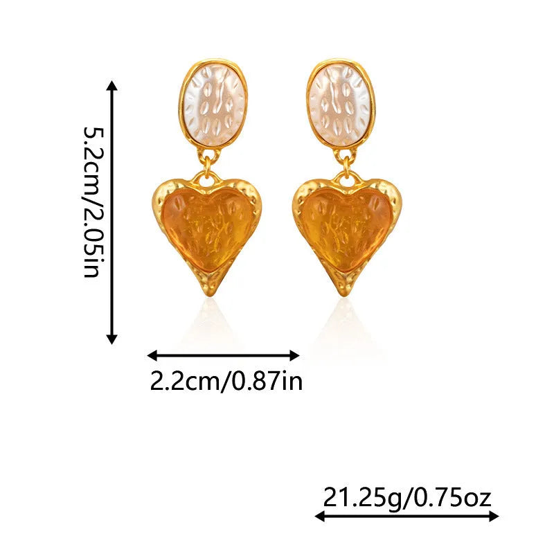 Close-up of oval love heart stud earrings with pleated needle posts in green, purple, red, and yellow-white colours.
